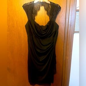 Tight, black dress with lace sleeves.